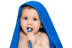 young boy brushing teeth